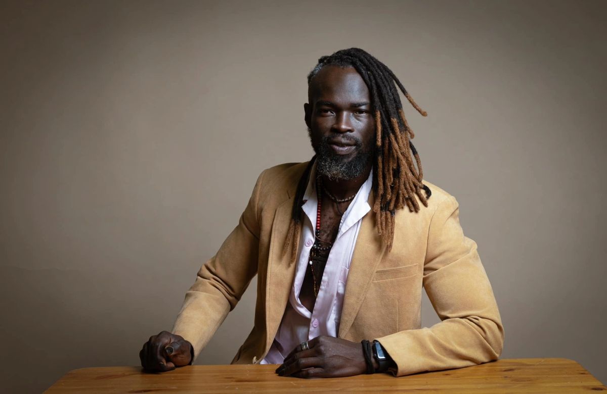 Photographer Samuel Obadero seated in his Calgary studio